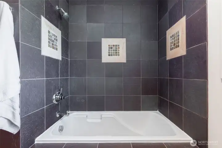 Oversized soaking tub with tiled surround