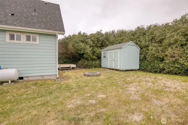 back yard has firepit and storage shed