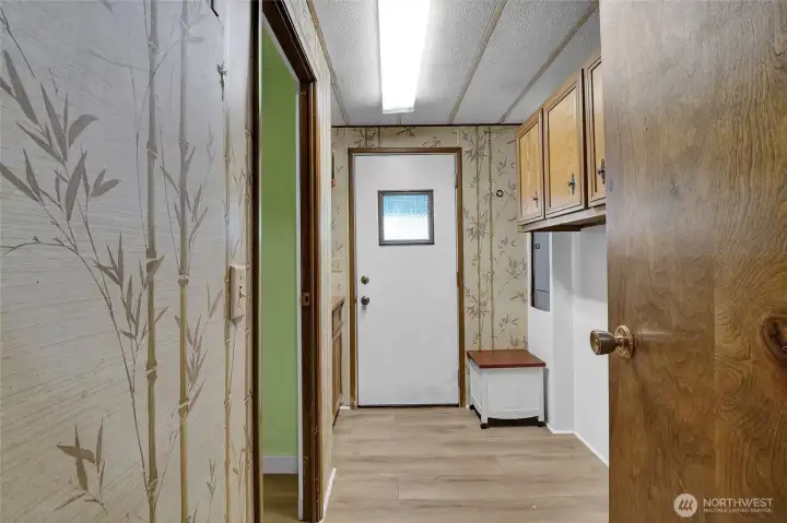 Large laundry room that leads to porch in the backyard