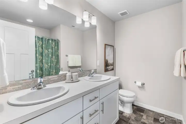 Hall bath with double vanity and tub