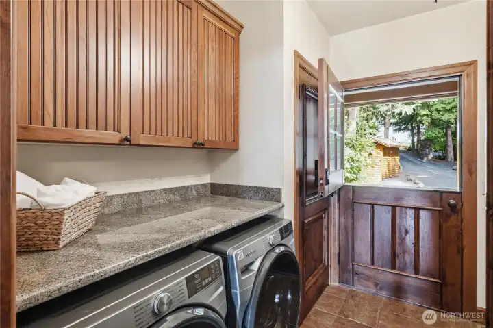 Laundry Room, with plenty of cabinets, Sink, and a Dutch Door that opens to the covered deck.