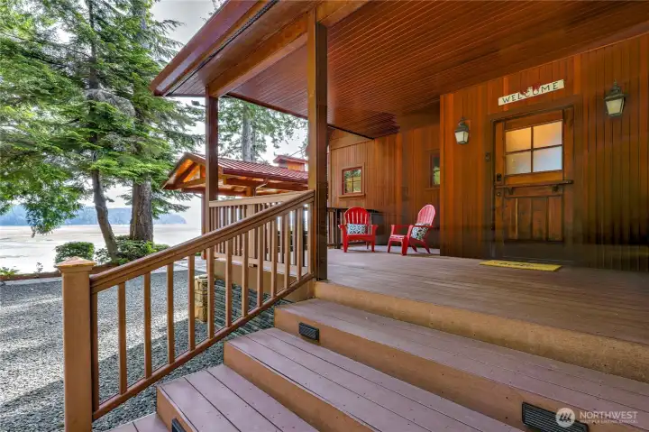 Covered composite deck, a sheltered outdoor living space tucked into the trees.