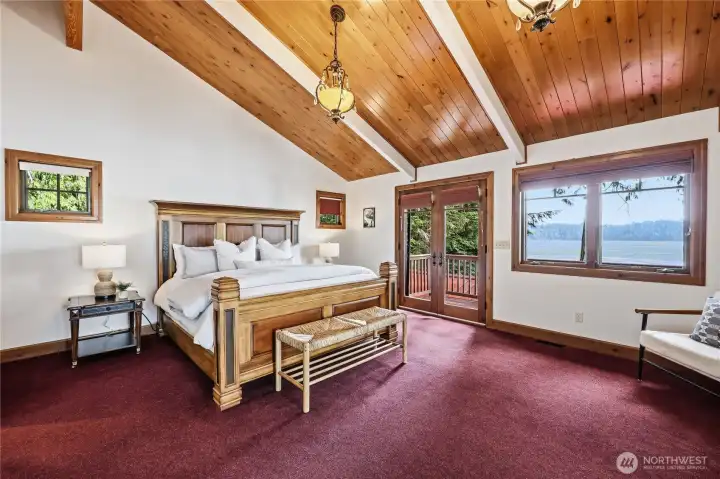 Vaulted tongue and groove ceiling in the primary... airy, warm, and unmistakably Pacific Northwest.