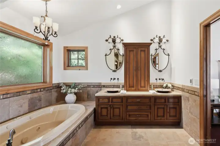 The primary bath is its own destination... soaking tub, double vanity, step in tiled shower, and walk-in closet.