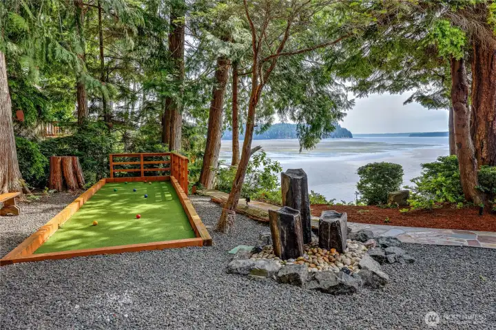 A putting green/bocce ball at water's edge.
