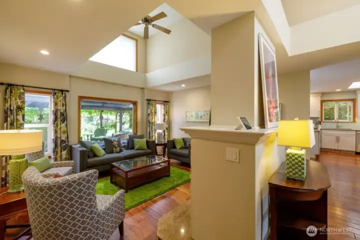 Ceiling fan in the living room.  Side of the fireplace so you can see how it anchors th ehome.