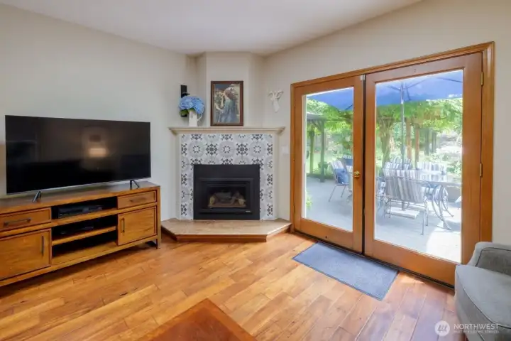 Step down into the family room off of the kitchen with French doors leading to the back deck, corner