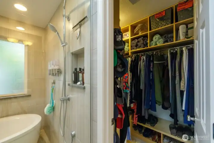 Large primary closet with built-in shelving.