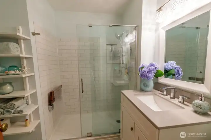 Off the entry is the second wing featuring full, updated bath with granite countertops and glass shower door.