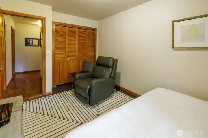 Second bedroom large enough for both a bed and a sitting area.