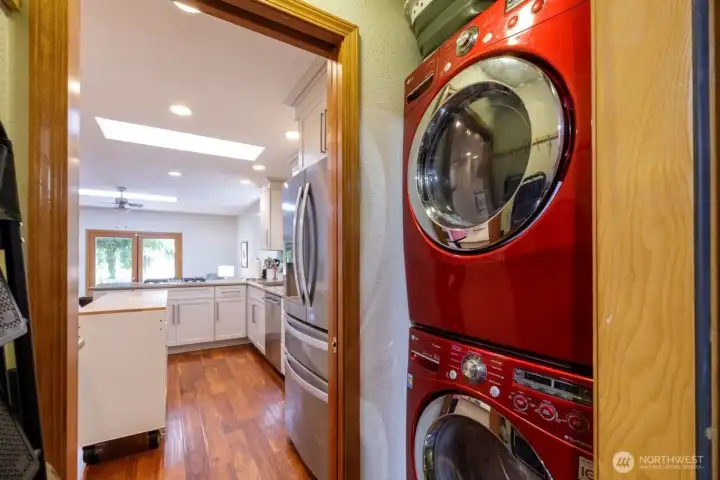 Utility room between the kitchen and the two-car garage with workspace and storage.