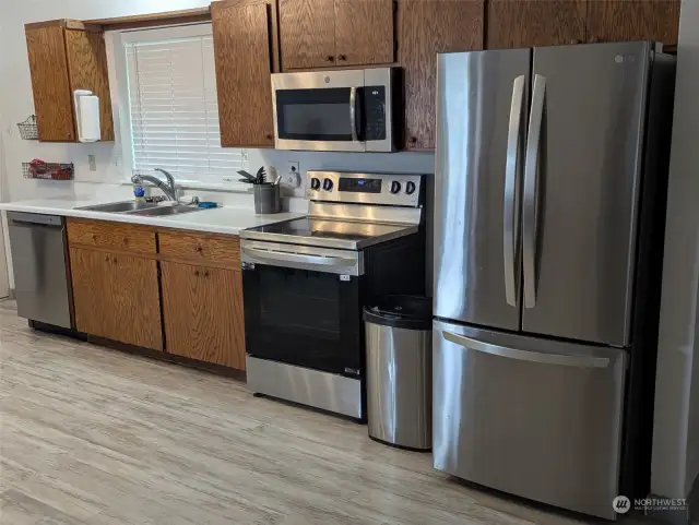 Newer Kitchen appliances. Laundry room is located just to the left.