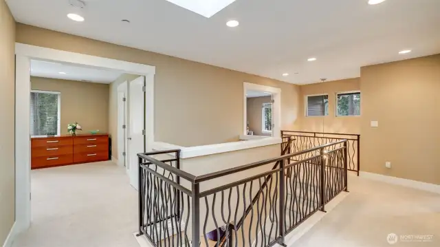 Custom railing with double door entry into primary suite. Skylight for natural light, newer top of the line carpet and new interior paint throughout.