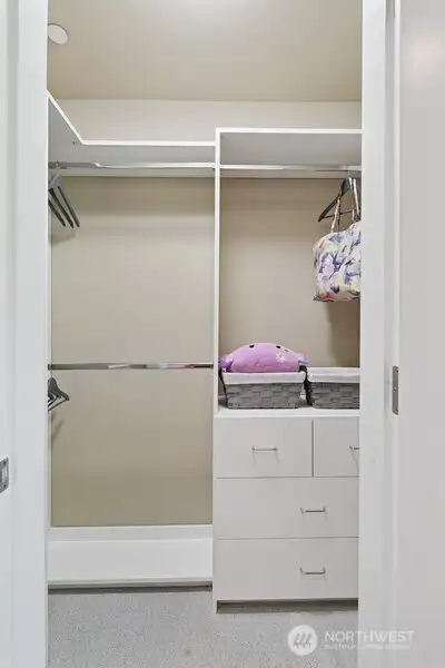 Bedroom #2 walk-in closet with high quality, custom built-ins.