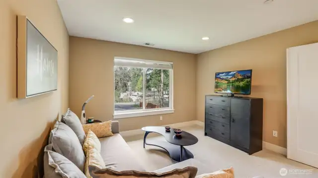 Upstairs large rec room with double door entry and large window or lots of natural light. Newer top of the line carpet & new interior paint.