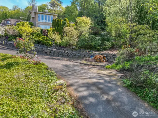 Building site drive way into lot next to this beautiful view home at end of the rock wall gets you into your 1.79 mostly flat ready to build view site.  Houses values are very high in this area