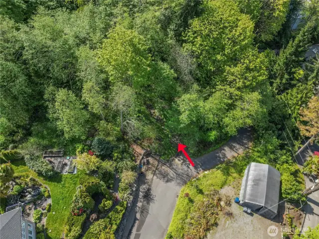 Entry road again into 1.79 acre property view with utilities in street outside of entry way to connect to.  Power already on property