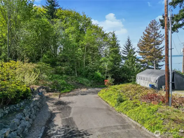 Entry road view with sound views to the right from property