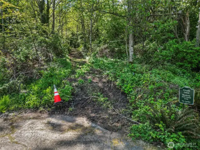 Partial cleared entry road at end of street going into 1.79 acre view property needing only to be cleared to build with wonderful sound views.  You can also get another 3 more building lots on property.  Confirm with City of Des Moines making this crazy good value