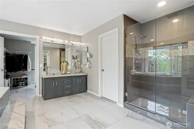 Oversized tiled shower with siting bench in the Master Bath create a richly romantic space