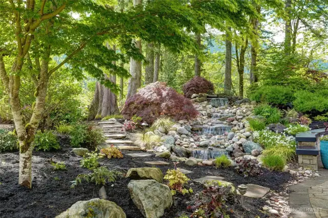 Stone walk way to your private sitting area, waterfall accents nestled within gardens of the northwest's finest.
