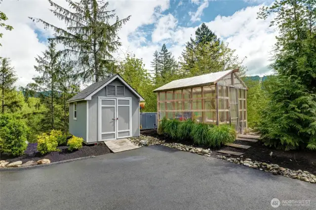 Another view of the Green house and Storage shed for all your lawn and garden tools. Pictured between them is the gas on-demand Whole House Generator.