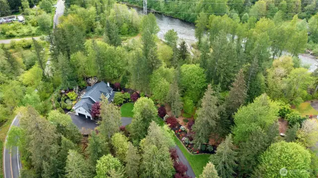 Aerial View of the property, located on a corner lot of privacy and backing to the South Fork of the Snoqualmie River with deeded access. Fish, Picnic and explore. Home is NOT within the Flood Plain and actually sits approx. 50+/- feet above the River Flow.