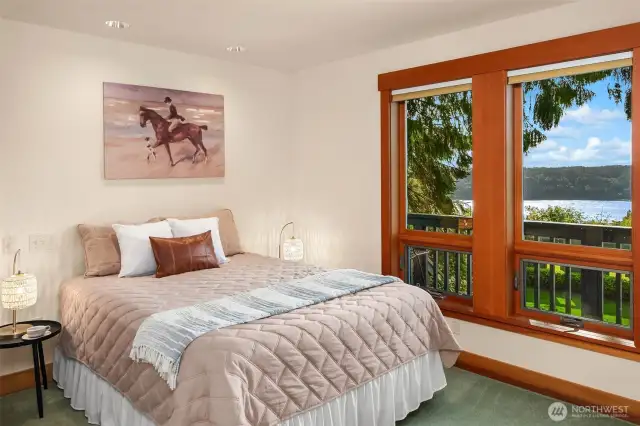 Main floor bedroom is across the hall from the full bath and has its own balcony with stairs down to pool area.