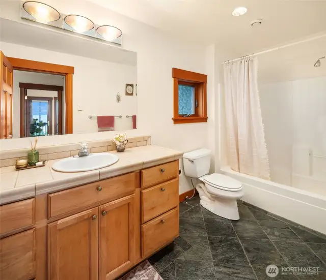 Main floor full bath across from main floor bedroom.