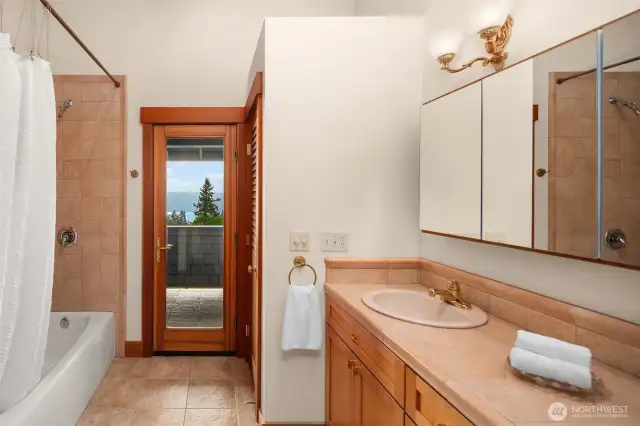 Primary en-suite bath has separate w/c room and access to the private balcony.