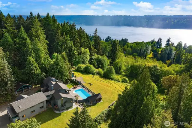 Nearly five acres of private meadows and forest with views of Colvos Passage and Olympic Mountains.