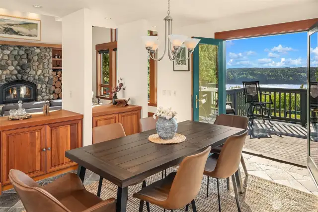 Dining room has cozy nook yet feels connected to the living room. French doors lead to view deck for dining al fresco on sunny summer days.