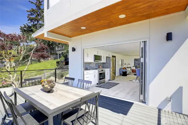 Deck off kitchen with seating area.