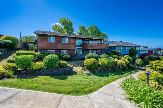 Back of house with mature landscaping