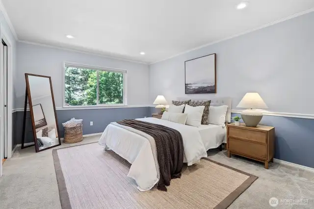 Primary bedroom suite upstairs with full bath and walk-in closet.