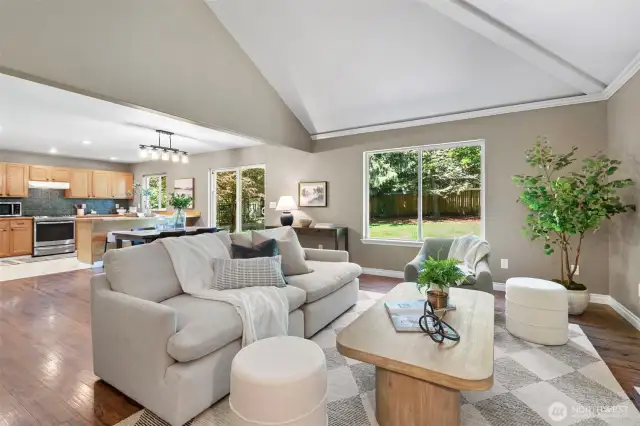 Open concept floor plan with vaulted ceilings and cozy gas fireplace