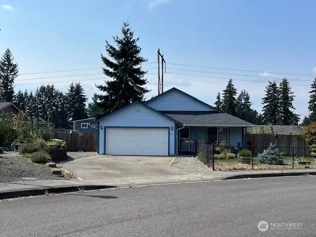 This beautiful one-story home sits on a large, private lot with a berry garden, room for your chickens and so much more!
