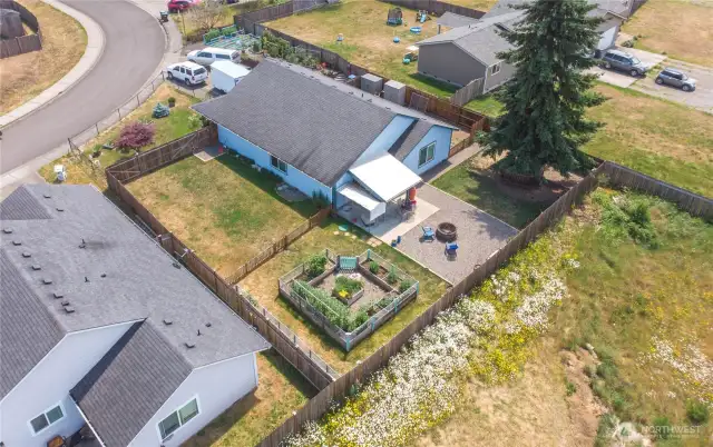 This 1/4-acre lot has a thriving vegetable garden, berry patch, room for your chickens & space to play