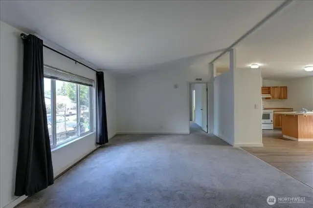 Opposite view of the living room with the primary suite at the far end. Note the vaulted ceilings!