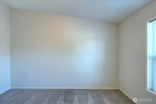 Bedroom 1. Both bedroom 1 and 2 are located at the opposite end of the home from the primary bedroom.
