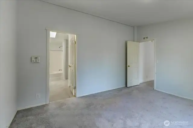 Primary bedroom with full ensuite bath and walk-in closet.