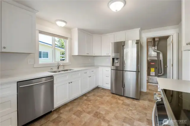 Utility/mudroom off kitchen offers additional storage