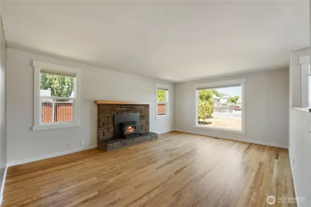 Large living room with wood-burning fireplace highlighting Wilkeson stacked brick hearth and chimney