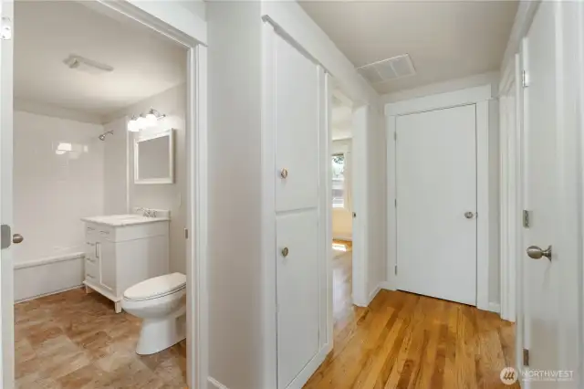Hallway leads to full bathroom and 3 roomy bedrooms