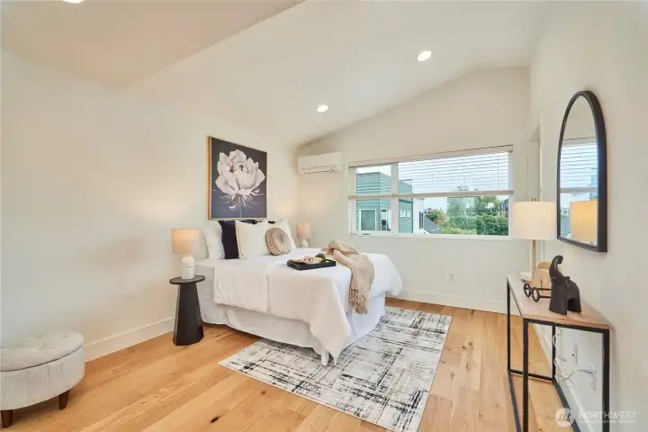 Wow! The primary suite is incredible! It boasts a territorial view, cathedral ceilings, ductless split heat/AC, oak hardwoods, access to a private covered deck, a walk in closet and a truly "spa-like" primary bathroom.