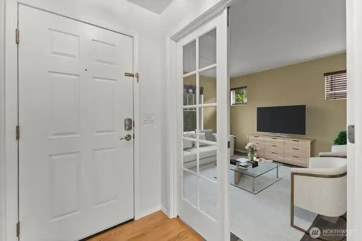 French doors lead you into the living room. Virtually staged.