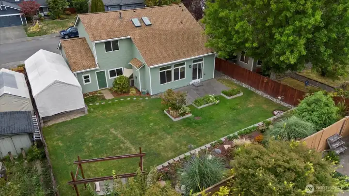 Aerial shot of the backyard & home. New Roof in 2017. New Gutters in 2021.