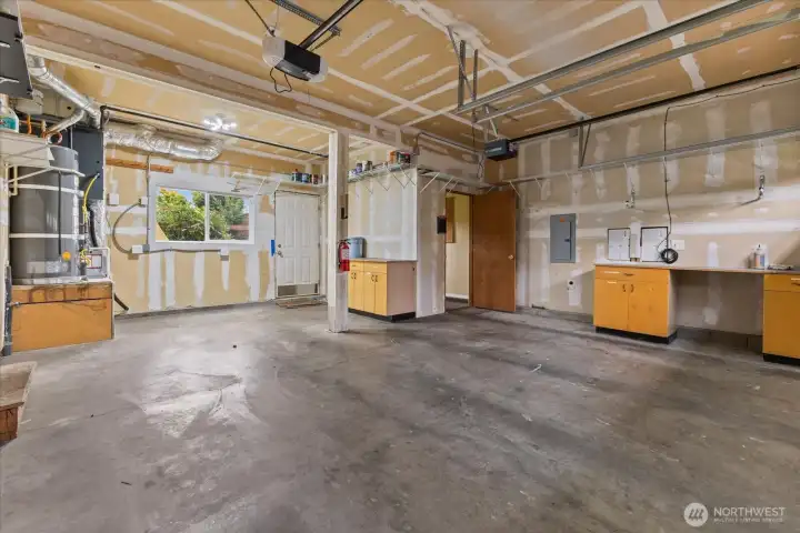 Garage w/ 220 outlet great for an electric vehicle charging unit. Built in room w/ power, great for hobby room, office or storage.