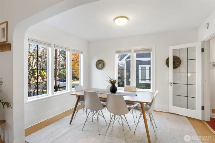 The gorgeous dining room with the tudor style archway and leaded glass paned windows and door to the kitchen.