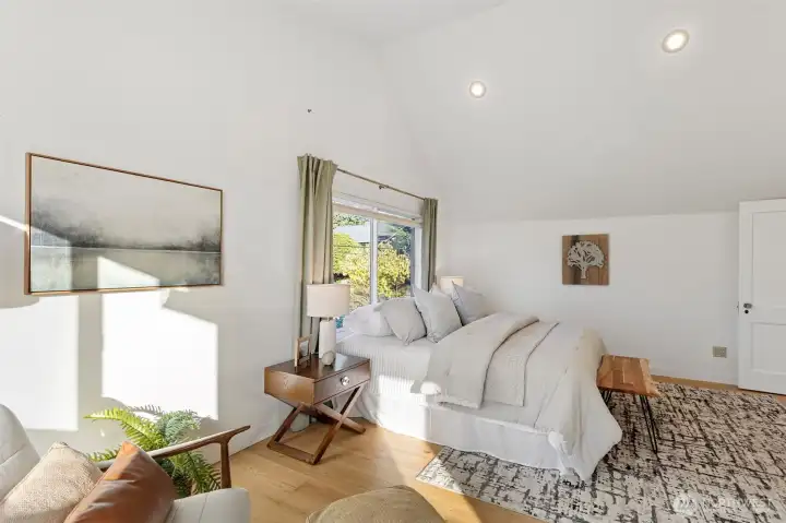 Another view of the primary bedroom with afternoon sun streaming in!